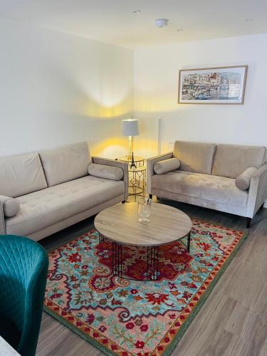 a living room with two couches and a coffee table at Riverside Double Room Garden View E14 in London
