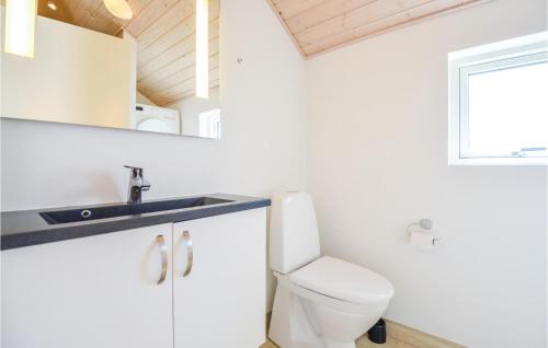 a bathroom with a toilet and a sink at Holiday Home Vestensøvej Ebeltoft Iv in Ebeltoft