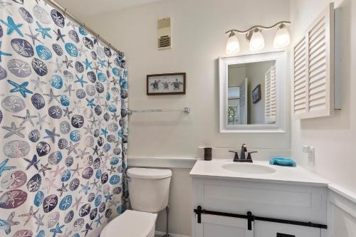 a bathroom with a toilet and a sink and a shower at The Spa 1219 in Hilton Head Island