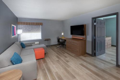 a living room with a couch and a tv at La Quinta by Wyndham New Braunfels in New Braunfels