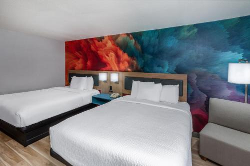a hotel room with two beds and a painting at La Quinta by Wyndham New Braunfels in New Braunfels