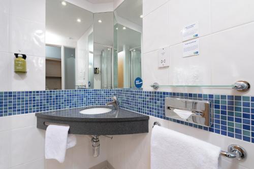 a bathroom with a sink and a mirror at Holiday Inn Express Ramsgate – Minster by IHG in Minster