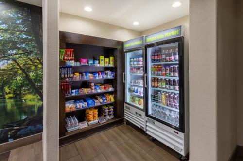 a convenience store with a refrigerator filled with drinks at La Quinta by Wyndham New Braunfels in New Braunfels