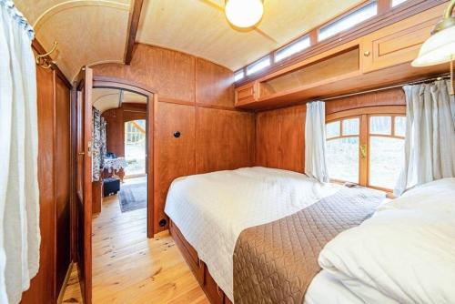 1 dormitorio con 2 camas en una habitación con paredes de madera en Zigappo Directeur, en Lychen
