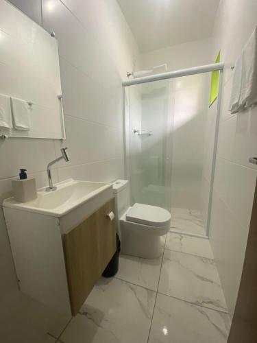 a bathroom with a sink and a toilet and a shower at Suites da Rota - Pomerode SC in Pomerode