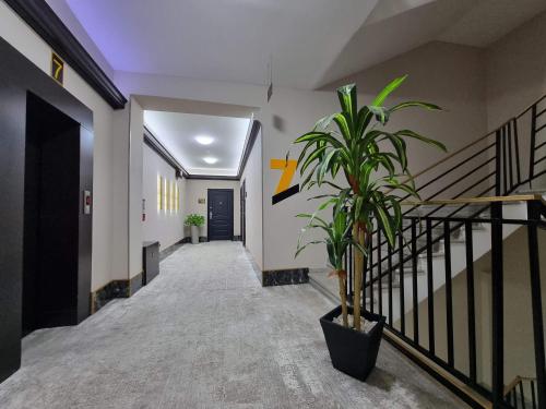 a hallway with stairs and a potted plant at MD Apart Hotel Tbilisi in Tbilisi City