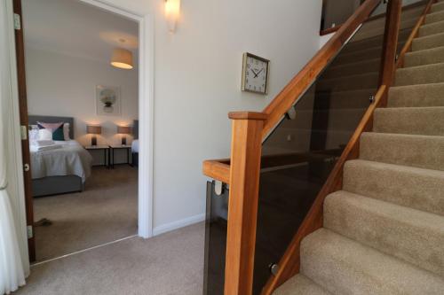 a hallway with stairs leading to a bedroom at Signature - Macneish House East Kilbride in East Kilbride