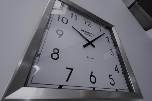 a clock hanging from the ceiling of a building at Signature - Macneish House East Kilbride in East Kilbride