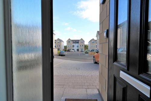 a view from a door of a street with houses at Signature - Macneish House East Kilbride in East Kilbride