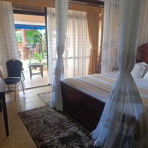 a bedroom with a bed with a canopy at North Coast Beach Hotel in Kikambala