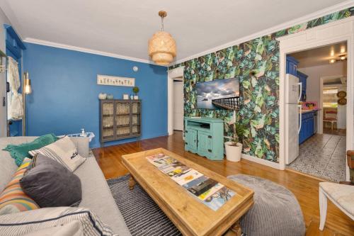 a living room with a couch and a table at Cozy Cottage Near Beach in Hollywood