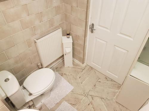 a bathroom with a toilet and a white door at East Central London -Studio in London