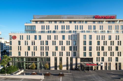 a large white building with a sign on it at Sheraton Bratislava Hotel in Bratislava