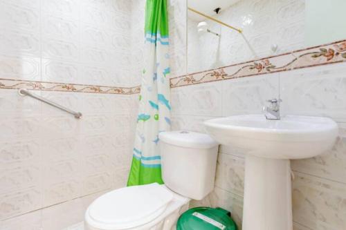 a bathroom with a toilet and a sink at Hotel Andino Real in Bogotá