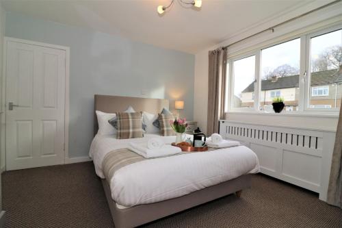 a bedroom with a bed and a large window at Signature - Gordon House in Glasgow