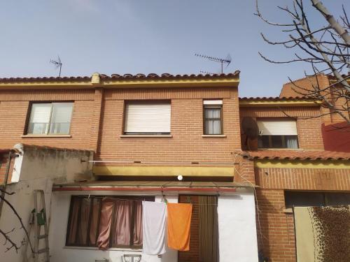 an apartment building with clothes hanging on a clothes line at Habitacion Privada Familiar Toledo in Toledo