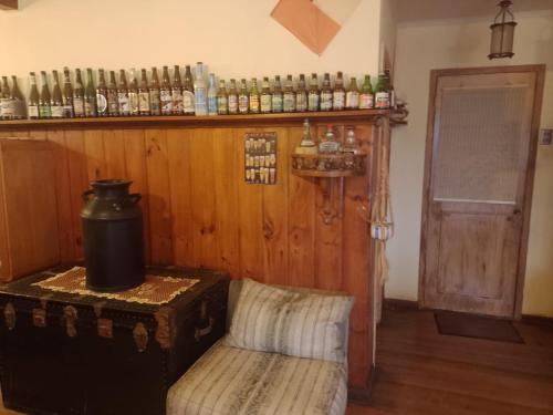 a room with a bar with a shelf with alcohol bottles at Pichidangui vista al Mar 8 camas in Los Vilos