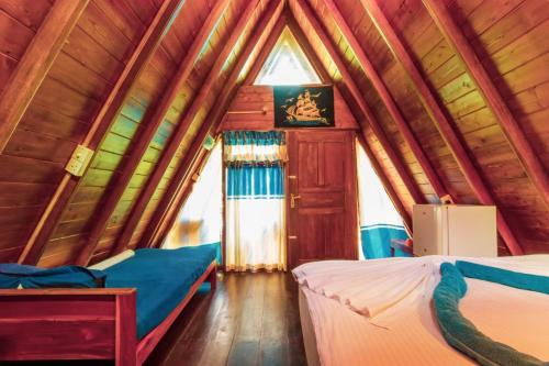 1 Schlafzimmer mit 2 Betten in einer Holzhütte in der Unterkunft That's Why Beach Cabanas Nilaveli in Nilaveli