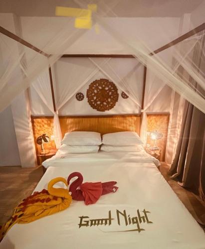 a bed in a tent with some decorations on it at Sandy Heaven Maldives in Gulhi