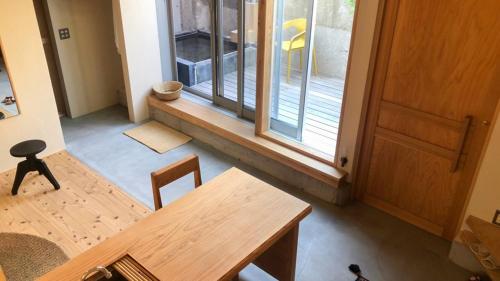 a dining room with a table and a window at Nisainoyuyado Asahiya in Beppu