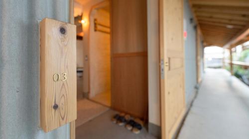 a wooden switch on the side of a hallway at Nisainoyuyado Asahiya in Beppu