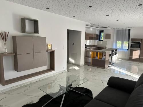 a living room with a couch and a kitchen at Appartement T3 Terrasse in Frontenex-Villard-Rosset