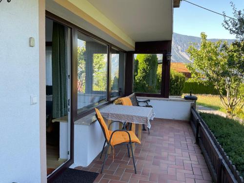 a patio with a table and chairs on a balcony at Comfortable apartment in a beautiful surrounding in Sautens