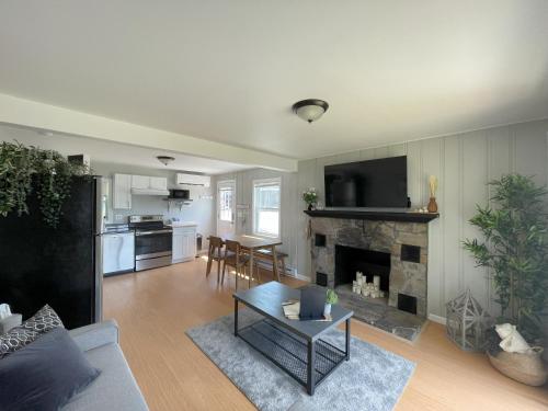 a living room with a couch and a fireplace at Thames River Cottage in Uncasville