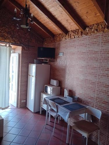 a kitchen with a refrigerator and a table and chairs at T1 N 93 Ref 001 in Tavira