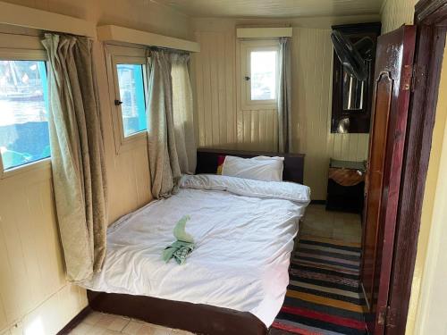 a bedroom with a bed with a bird on it at Floating Hotel- Happy Nile Boat in Luxor