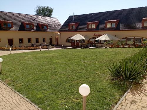 a courtyard of a hotel with tables and chairs at Sport - Relax Buky in Františkovy Lázně