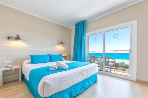 - une chambre avec un lit et une vue sur l'océan dans l'établissement ALEGRIA Maripins, à Malgrat de Mar