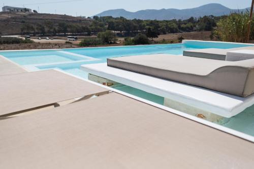 a bed on the roof of a house at Aegean Feelings in Piso Livadi