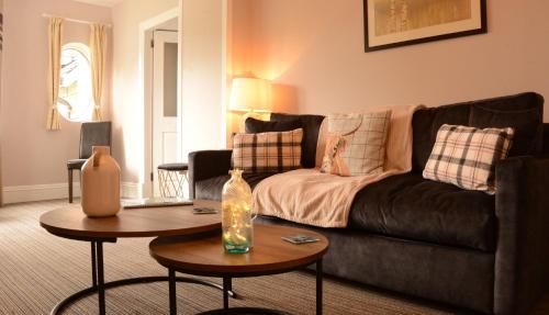 a living room with a couch and a table at Creag Mhor Lodge in Onich
