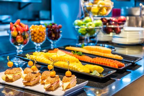 a buffet with two trays of food on a table at Hilton DoubleTree Bogotá Salitre AR in Bogotá