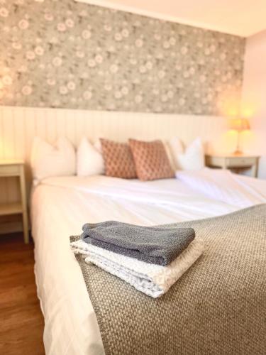a bedroom with a bed with two towels on it at Hotell & Restaurant Solliden in Stenungsund