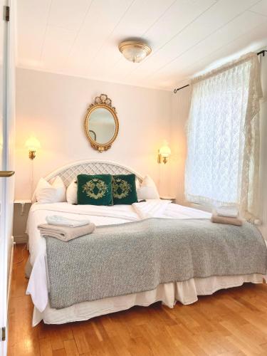 a bedroom with a large bed and a mirror at Hotell & Restaurant Solliden in Stenungsund