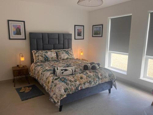 a bedroom with a bed with shoes on it at Magilligan - Cottage - Sleeps 6 - Parking - Garden in Aghanloo