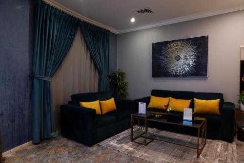a living room with a blue couch and yellow pillows at شقق سوات للشقق المخدومة 2 in Al Khobar