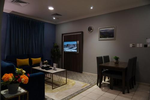 a living room with a couch and a table at شقق سوات للشقق المخدومة 2 in Al Khobar