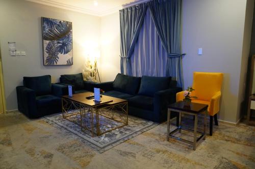 a living room with a couch and two tables at شقق سوات للشقق المخدومة 2 in Al Khobar