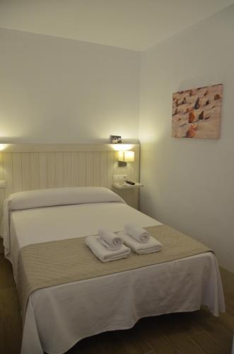 Cama o camas de una habitación en Hostal La Fonda
