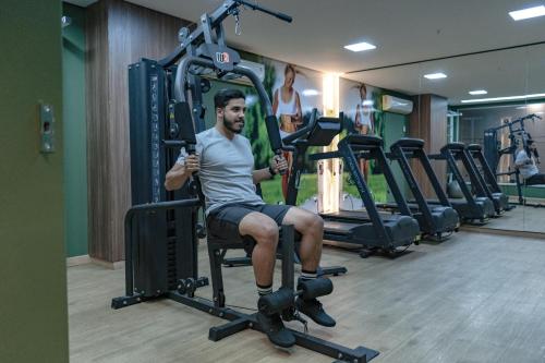 a man sitting on a chair in a gym at Intercity Montes Claros in Montes Claros