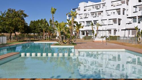 a swimming pool in front of a building at casa paradisiaca in Murcia