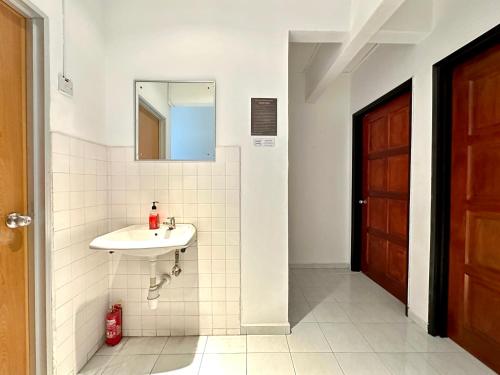 a bathroom with a sink and a mirror at BNB Cozy Homestay @ Bdr Country Homes (Corner Hse) in Rawang