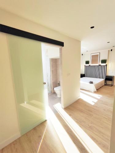 a room with a door open to a living room at Puertollano Central Park - by Pro Apartments - Free Parking in Puertollano