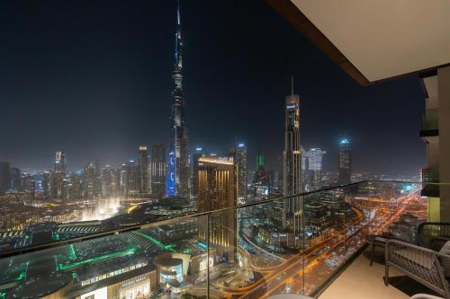 a view of a city skyline at night at Ultimate Stay Full Burj Khalifa & Downtown Views Designer Luxury High Floor for 6 People in Dubai