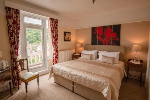 a bedroom with a large bed and a window at Rockvale House in Lynton