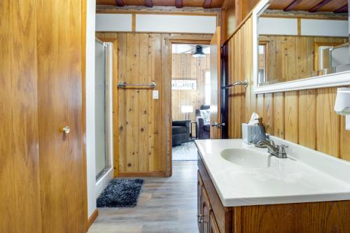 a bathroom with a sink and a mirror at Lakefront Marenisco Cabin with Private Dock! in Bergland