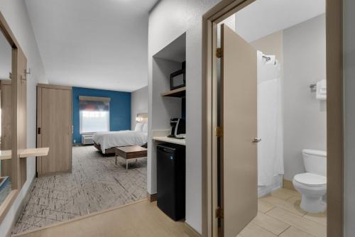 uma casa de banho com WC e uma cama num quarto em Holiday Inn Express Destin E - Commons Mall Area, an IHG Hotel em Destin
